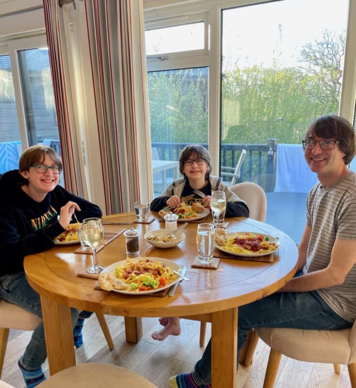 Family of Dad and two boys having dinner in a Hoseasons lodge